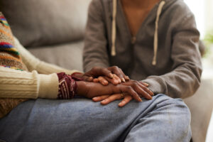 A woman and her daughter hand in hand.