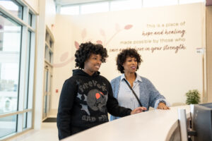 young girl with mother going through discharge out of mental health hospital