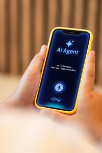 Teenage boy holding a smartphone and interacting with an AI assistant application on the screen. 