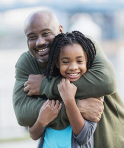 man hugging youth, compassionate, positive and upbeat
